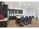 Modern kitchen with island, dark cabinets, and light floors at 144 Juliette Pointe Ln, Henderson, NV 89011