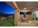 Evening view of backyard patio with seating area and city lights at 144 Juliette Pointe Ln, Henderson, NV 89011