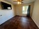 Bedroom with tile floors, large TV and window coverings at 2120 Ramrod Ave # 415, Henderson, NV 89014