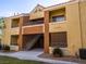 Tan two-story building with balconies and stairs at 2120 Ramrod Ave # 415, Henderson, NV 89014