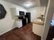 Galley kitchen features black appliances and tile flooring at 2120 Ramrod Ave # 415, Henderson, NV 89014