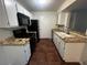 Efficient kitchen with black appliances and tile countertops at 2120 Ramrod Ave # 415, Henderson, NV 89014