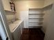 Laundry room with washer, dryer and shelving unit at 2120 Ramrod Ave # 415, Henderson, NV 89014