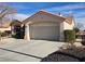 View of the home's exterior, highlighting the two-car garage and landscaping at 3020 Ripon Dr, Las Vegas, NV 89134