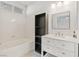 Clean bathroom with a bathtub, vanity, and shelving unit at 5372 Polo Grounds St, Las Vegas, NV 89148