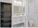 Clean bathroom with white vanity, large mirror, and a separate toilet area at 5372 Polo Grounds St, Las Vegas, NV 89148