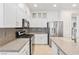 Modern kitchen with white cabinets, granite countertops, and stainless steel appliances at 5372 Polo Grounds St, Las Vegas, NV 89148