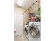 Laundry room with washer, dryer, and ample storage shelves at 5372 Polo Grounds St, Las Vegas, NV 89148