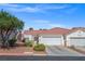 Well-maintained stucco home with tile roof, landscaping, and a two-car garage at 5683 Whale Watch St, Las Vegas, NV 89113