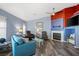 Living room with fireplace, hardwood floors, and ample natural light at 5683 Whale Watch St, Las Vegas, NV 89113