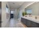 Modern bathroom with a glass shower, dual sinks, and a large mirror, boasting sunset views at 673 Falcon Cliff Ct, Henderson, NV 89012
