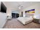Bright bedroom boasts a ceiling fan, desk, and a sliding glass door to the outside at 673 Falcon Cliff Ct, Henderson, NV 89012