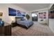 Stylish bedroom featuring patterned carpet, neutral walls, and a sliding glass door to the outside at 673 Falcon Cliff Ct, Henderson, NV 89012