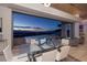 Elegant dining area showcases a glass table, seating for six, and stunning city views at 673 Falcon Cliff Ct, Henderson, NV 89012
