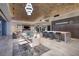 Open-plan dining area with modern chandelier next to gourmet kitchen area at 673 Falcon Cliff Ct, Henderson, NV 89012