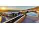Exterior view of home at sunset with a pool and city views in the distance at 673 Falcon Cliff Ct, Henderson, NV 89012