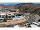 Aerial view of a modern luxury home with a pool and manicured landscaping on a hillside at 673 Falcon Cliff Ct, Henderson, NV 89012