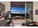 Well-equipped fitness center with sliding glass doors to a patio with a fire pit and city views at 673 Falcon Cliff Ct, Henderson, NV 89012