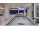 Open-concept game room with a pool table, city view, and access to a wet bar at 673 Falcon Cliff Ct, Henderson, NV 89012