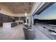 Spacious living room with modern kitchen, comfortable seating, and sliding doors with city views at 673 Falcon Cliff Ct, Henderson, NV 89012