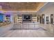Open-concept living room with bar, modern fireplace, and beautiful lighting at 673 Falcon Cliff Ct, Henderson, NV 89012
