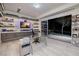 Bright office boasts built-in shelving, desk, and a sliding glass door leading to a landscaped outdoor area at 673 Falcon Cliff Ct, Henderson, NV 89012