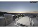 Outdoor kitchen and dining table with mountain views in the distance at 673 Falcon Cliff Ct, Henderson, NV 89012