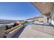 Enjoy the outdoor living space with a fireplace and pool overlooking city views at 673 Falcon Cliff Ct, Henderson, NV 89012