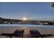 Enjoy a sunset view from the pool on the patio at 673 Falcon Cliff Ct, Henderson, NV 89012