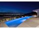 Experience luxury with an infinity pool showcasing breathtaking city views under the night sky at 673 Falcon Cliff Ct, Henderson, NV 89012