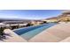 Enjoy this long, modern infinity pool with fantastic views on a sunny day at 673 Falcon Cliff Ct, Henderson, NV 89012