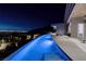 Luxury home featuring a stunning infinity pool with city views at night at 673 Falcon Cliff Ct, Henderson, NV 89012