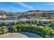 This sprawling estate features a pool, multiple outdoor lounge areas, and lush landscaping at 677 Boulder Summit Dr, Henderson, NV 89012