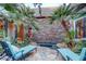 Serene outdoor area with stone patio, lounge chairs, spa, and lush landscaping at 677 Boulder Summit Dr, Henderson, NV 89012