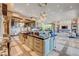 Bright kitchen showcasing an island with granite countertops, ample cabinetry, and modern lighting fixtures at 677 Boulder Summit Dr, Henderson, NV 89012