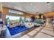 Bright living room featuring sleek tile floors, modern furniture, and beautiful outside views at 677 Boulder Summit Dr, Henderson, NV 89012