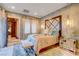 Cozy bedroom with decorative wall art, pendant lights, and ensuite bathroom at 677 Boulder Summit Dr, Henderson, NV 89012