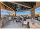 Outdoor dining area with a built-in grill and comfortable seating offers scenic views for enjoyable meals at 677 Boulder Summit Dr, Henderson, NV 89012