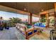 A relaxing outdoor swing and lounge area offers stunning views and comfortable seating for enjoying the scenery at 677 Boulder Summit Dr, Henderson, NV 89012