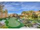 Backyard putting green with sand traps, gazebo and water feature provide recreation and relaxation at 677 Boulder Summit Dr, Henderson, NV 89012