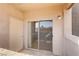 Balcony with sliding glass doors, concrete flooring, stucco ceilings and walls, and security door at 7701 Himalayas Ave # 104, Las Vegas, NV 89128