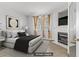 Bedroom includes fireplace, large window, and neutral-toned decor for a cozy feel at 7701 Himalayas Ave # 104, Las Vegas, NV 89128