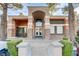 Building entrance with stone accents and landscaping at 7701 Himalayas Ave # 104, Las Vegas, NV 89128