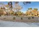 Well-maintained common area featuring mature trees, rock landscaping, and walking path at 7701 Himalayas Ave # 104, Las Vegas, NV 89128