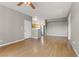 Spacious living area flows into the kitchen, featuring hardwood floors and neutral paint at 7701 Himalayas Ave # 104, Las Vegas, NV 89128
