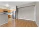 Open-concept space featuring hardwood floors and views of the kitchen with stainless steel appliances at 7701 Himalayas Ave # 104, Las Vegas, NV 89128