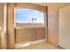 Private patio with arched entryway and view of trees at 7701 Himalayas Ave # 104, Las Vegas, NV 89128