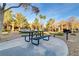 Metal picnic table with benches in a paved courtyard at 7701 Himalayas Ave # 104, Las Vegas, NV 89128