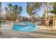 Sparkling community pool featuring palm trees and ample lounging furniture at 7701 Himalayas Ave # 104, Las Vegas, NV 89128