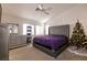 Cozy bedroom with a tufted headboard, dresser, carpeted floors, and natural light from the window at 7936 Dexter Falls St, Las Vegas, NV 89149